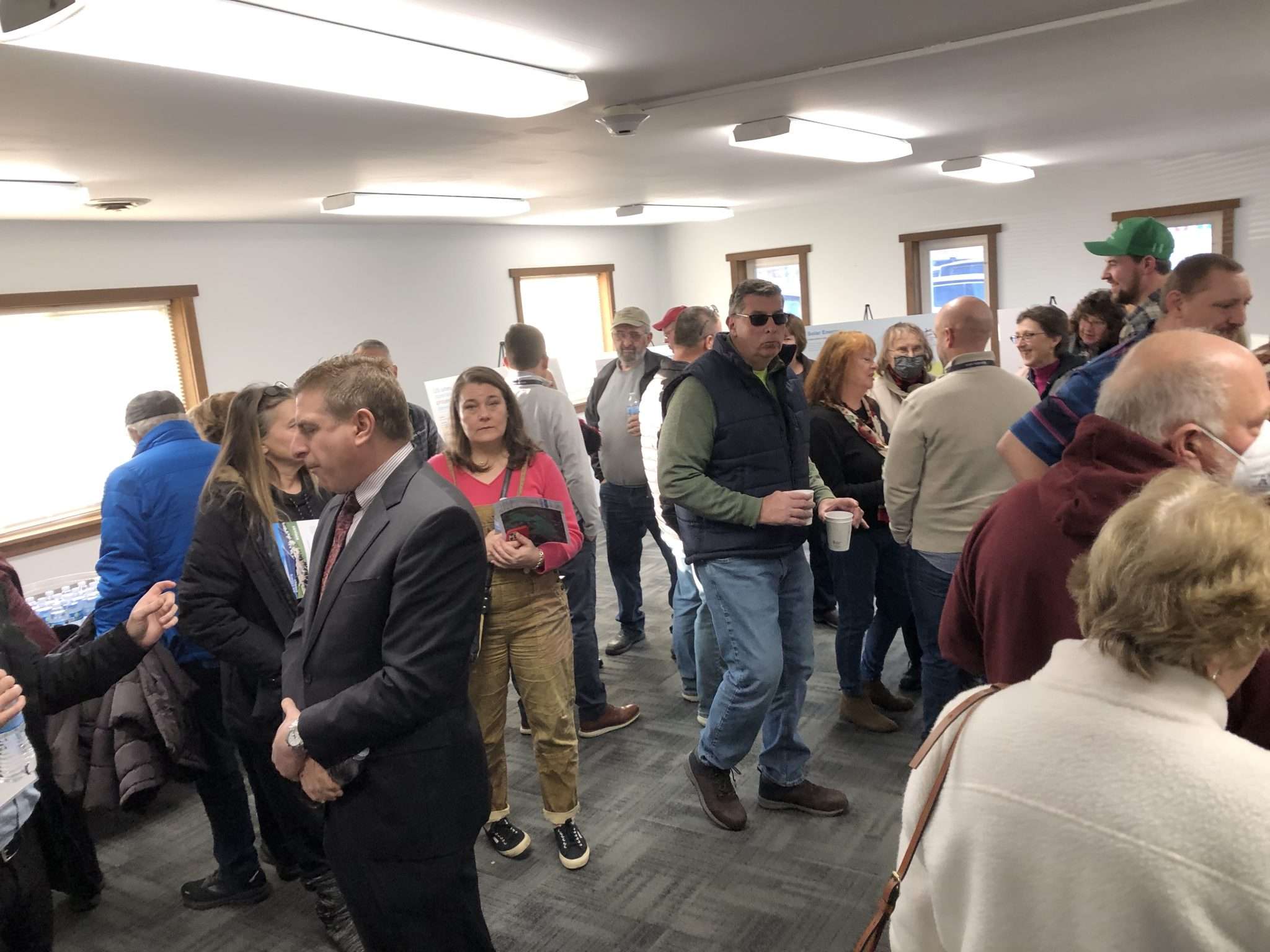 A room full of people at the Mayfield Fire House learn more about a proposed 40-megawatt solar project on a farm in the town.