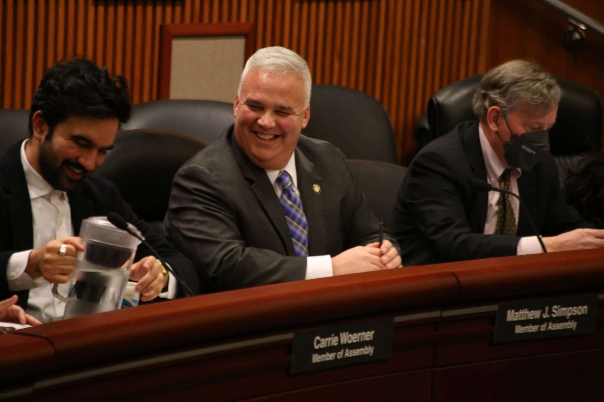 Assemblyman Matthew Simpson laughing during a budget hearing in the New York State Capitol in Albany.