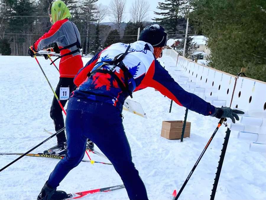 Skiers grab new maps that will tell them where checkpoints are located within the forest