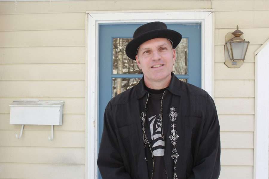 Echo Only stands in front of his home in Saranac Lake.