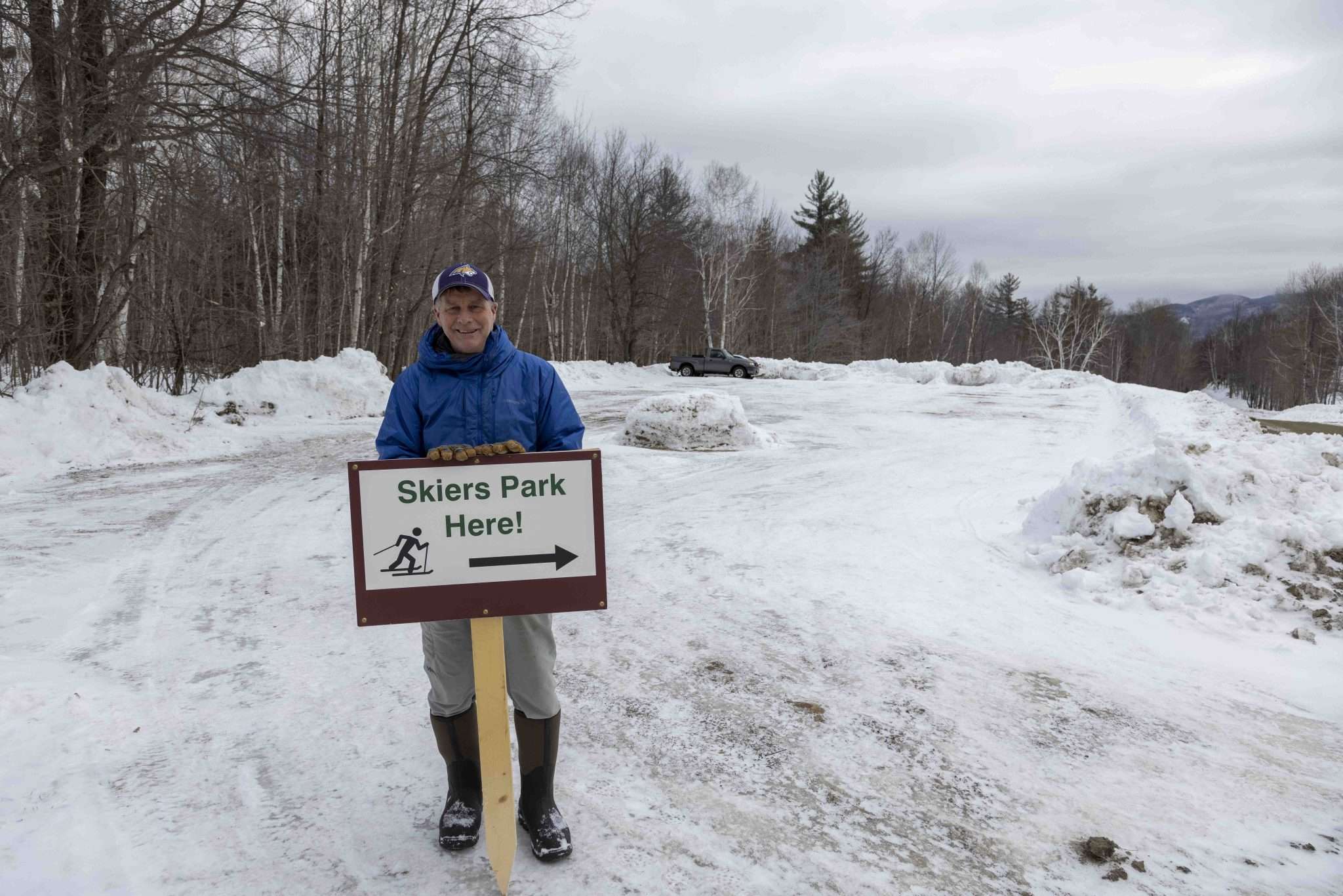 Ed Palen stands in front of a parking lot on his property that he created in recent years to accomodate skers visiting the Keene section of the Jackrabbit Trail. Photo by Mike Lynch
