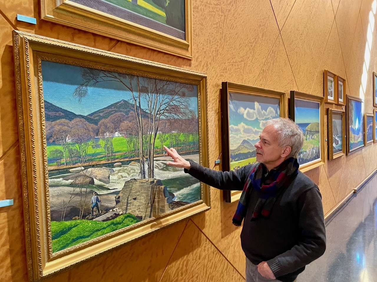 Ferris examining a Kent painting of the falls on the East Branch of the Ausable River in Jay.