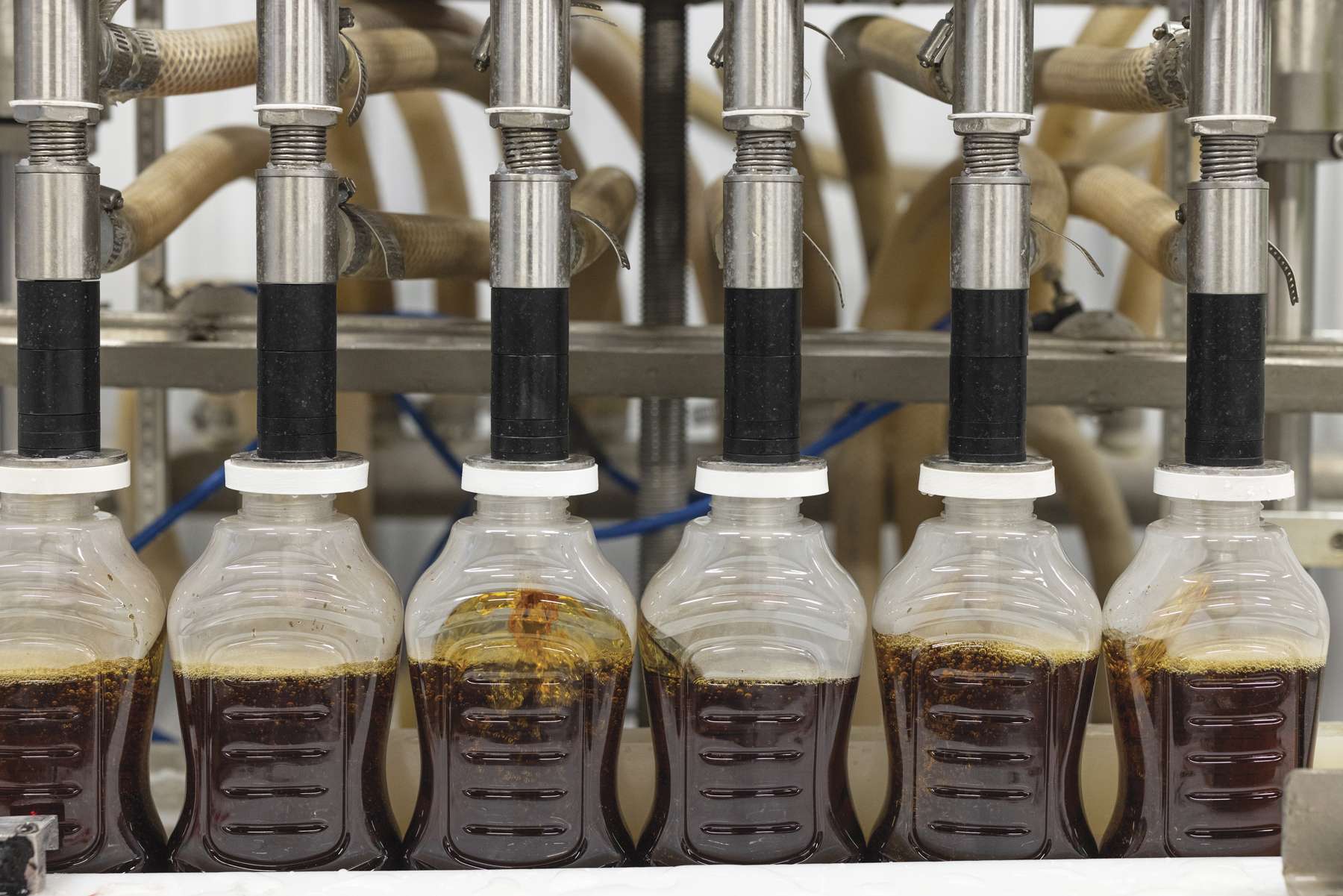 Bottles are filled with syrup inside the New Leaf Tree Syrups sugar house. Photo by Mike Lynch