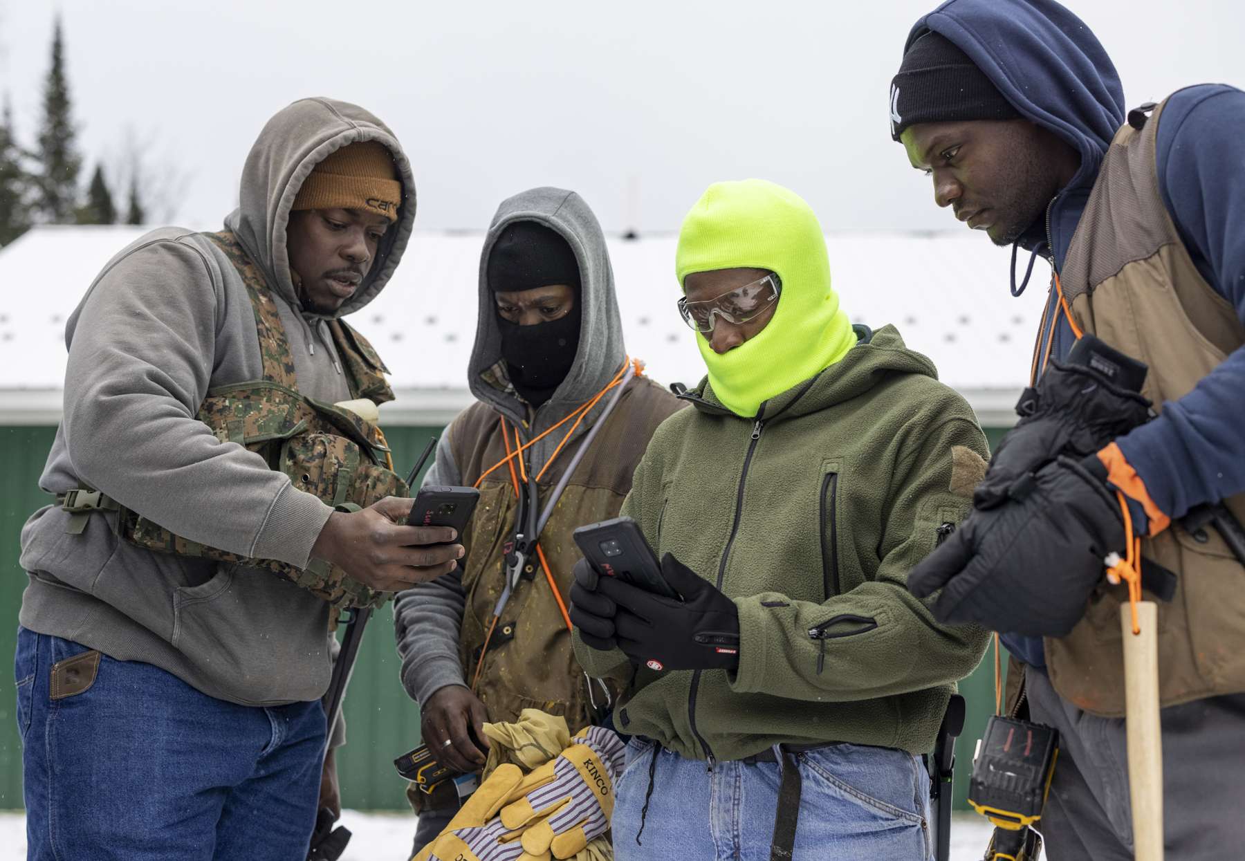 The crew familiarizes themselves with  company issued smart phones and a app designed for keeping track of progress during the tapping season. The managers use the data for planning purposes. Photo by Mike Lynch