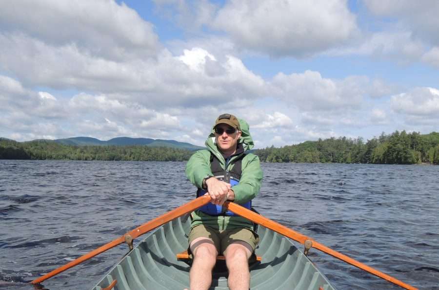 Associate Director of the the SUNY ESF Adirondack Ecological Center rows on a lake.
