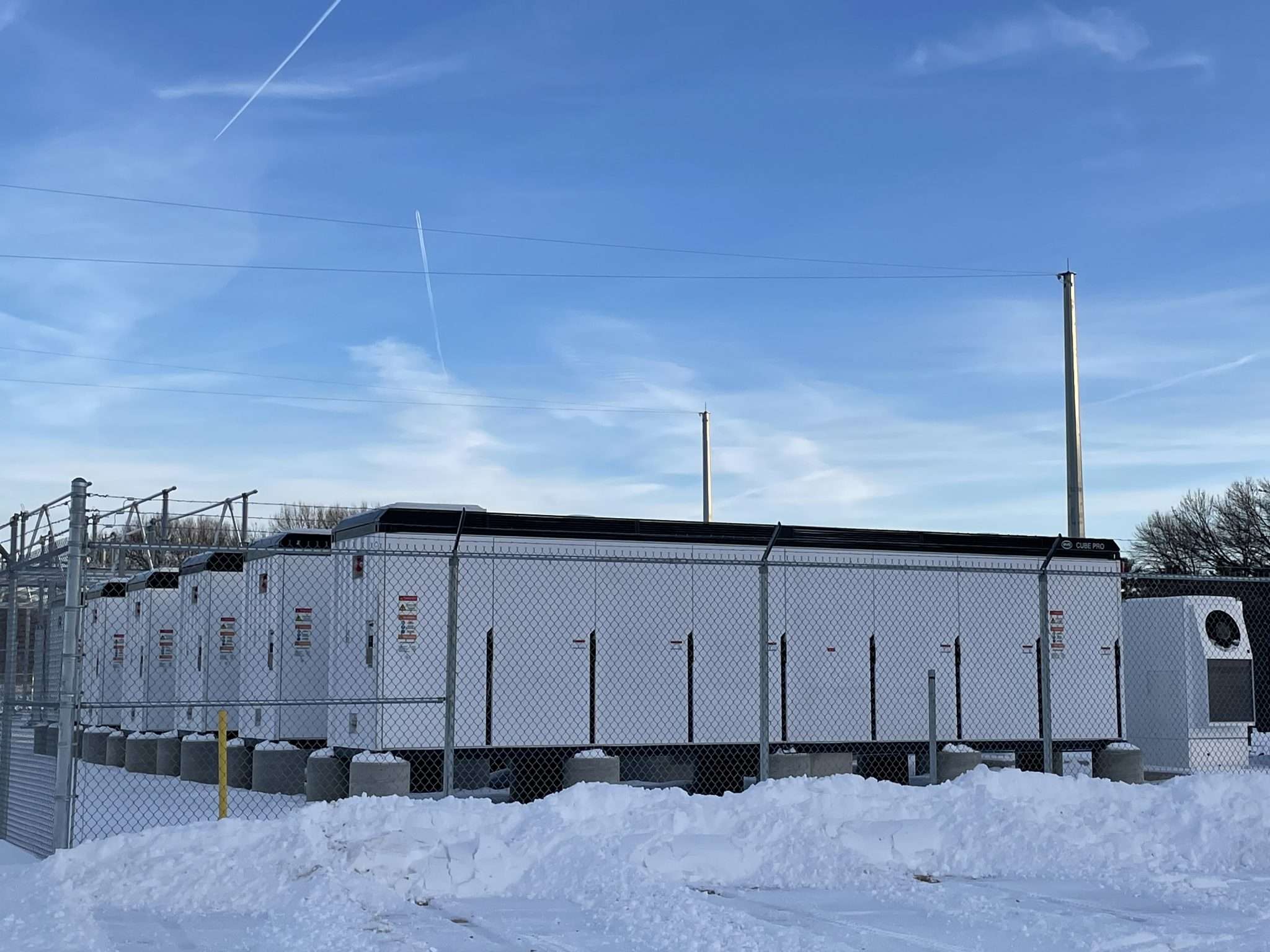 These battery modules, supplied by the battery company BYD, show a similar-sized project to the one proposed in the hamlet of Raquette Lake. The batteries look like a long trailer on concrete mounts.