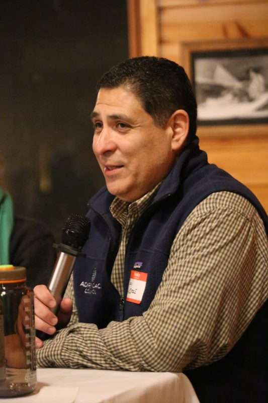 Holding a microphone, Raul “Rocci” Aguirre, acting director of the Adirondack Council, speaks on a panel about diversity, equity and inclusion on Friday, March 10, 2023 at Camp Chingachgook in Fort Ann