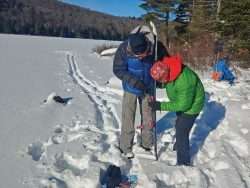 Steve Goldstein, right, helps Phil Brown repair a broken binding near the shore of Siamese Ponds.