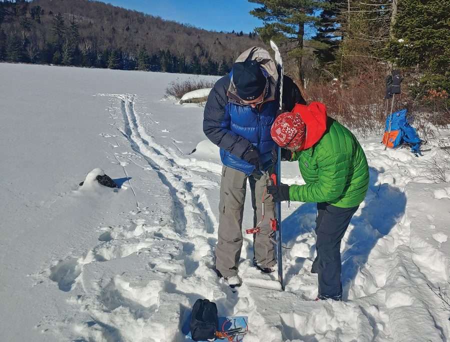 Steve Goldstein, right, helps Phil Brown repair a broken binding near the shore of Siamese Ponds. 