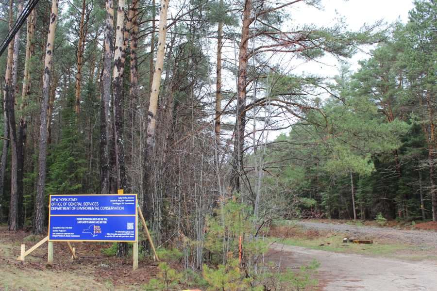 A large blue sign shows that the state has closed the Adirondack Rail Trail during construction.