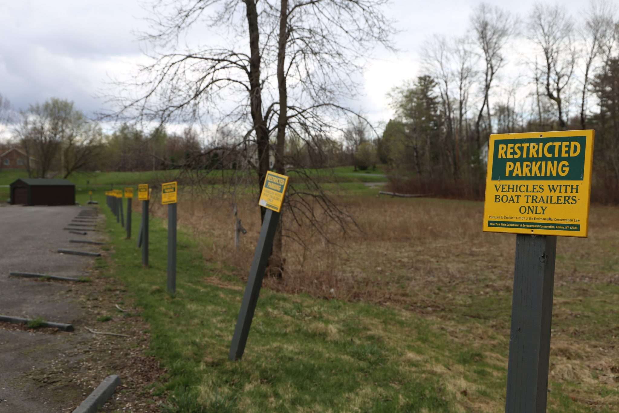 Restricted parking signs line every spot in the Broadalbin Boat Launch area's parking lot.