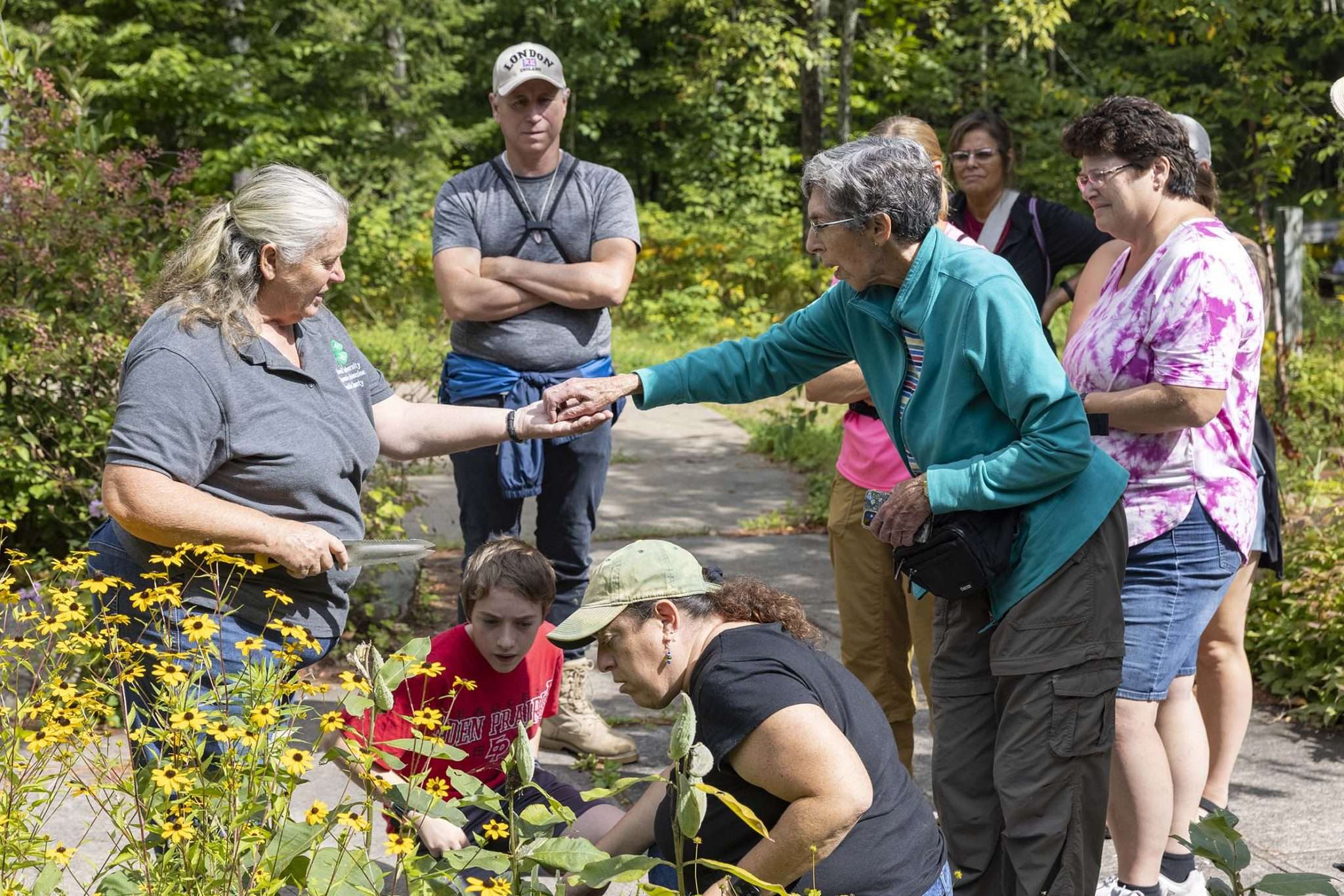 Pat Banker, of Cornell University Cooperative Extension, is an expert in wild edible plants. Here, she leads a tour at the Paul Smiths VIC on Wednesday, August 24. Photo by Mike Lynch