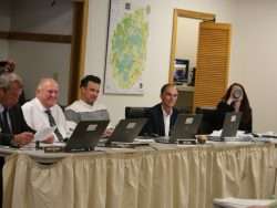 Board members of the Adirondack Park Agency sit at a table