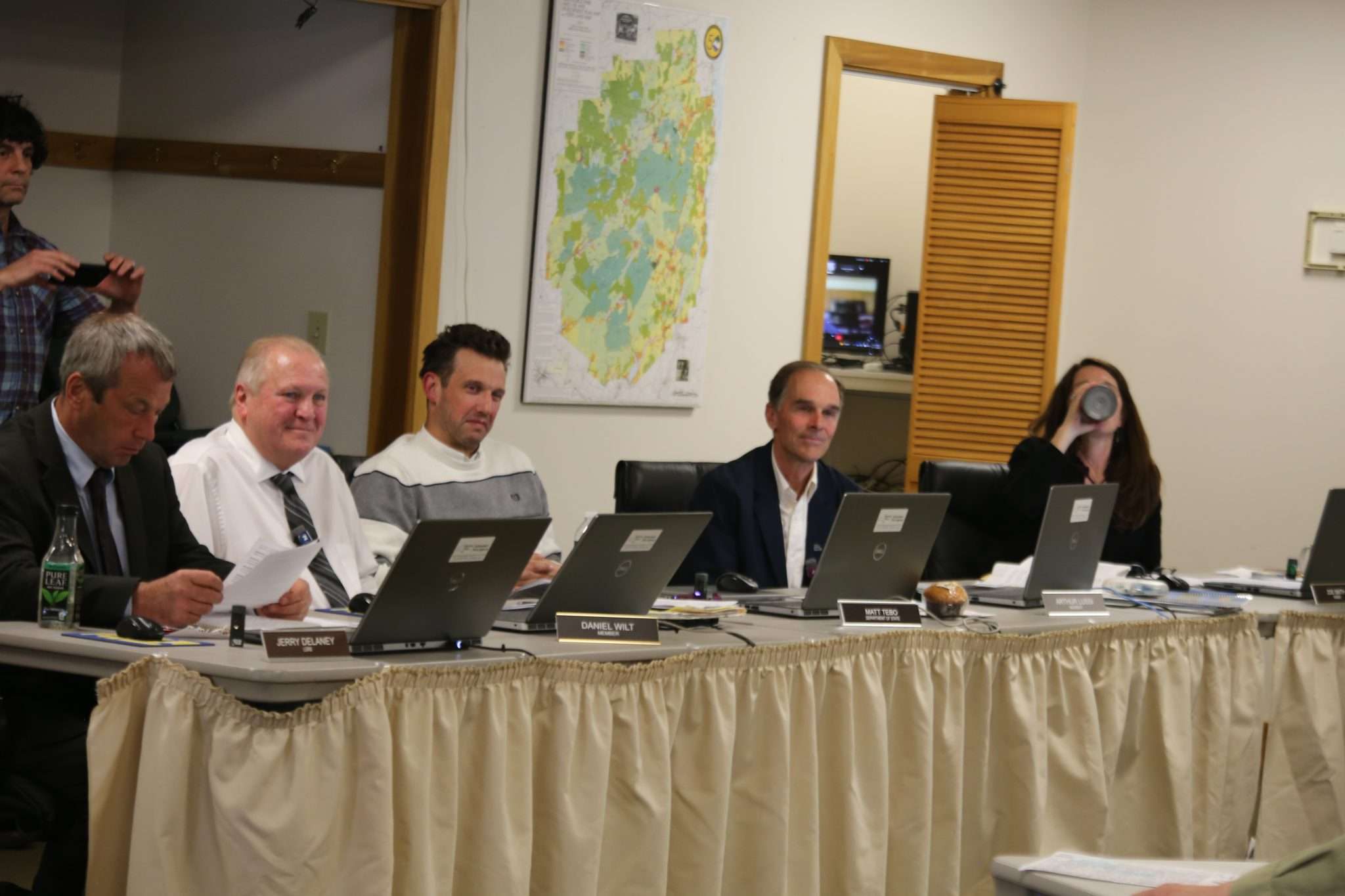 Board members of the Adirondack Park Agency sit at a table