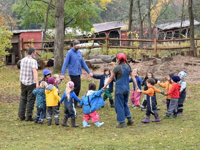 kids and teachers outside in a circle at Lakeside School