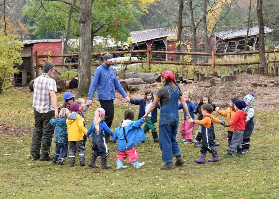 kids and teachers outside in a circle at Lakeside School