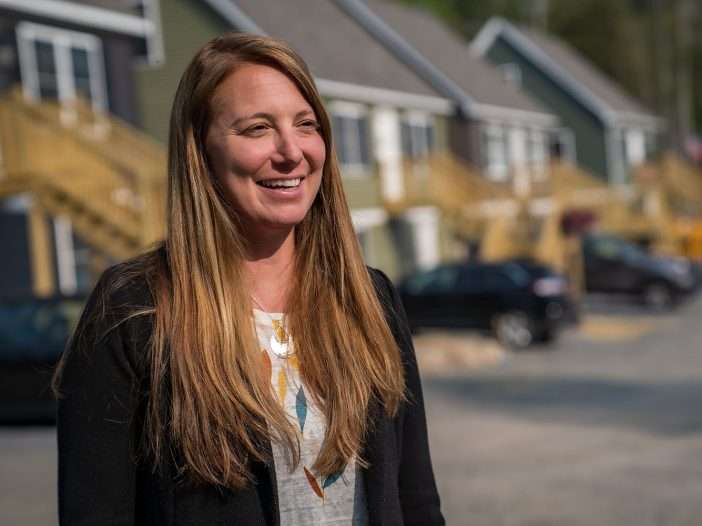 woman in front of housing development