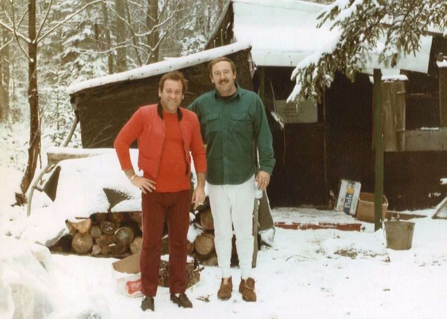 two men in front of a rustic camp at Pa's Falls