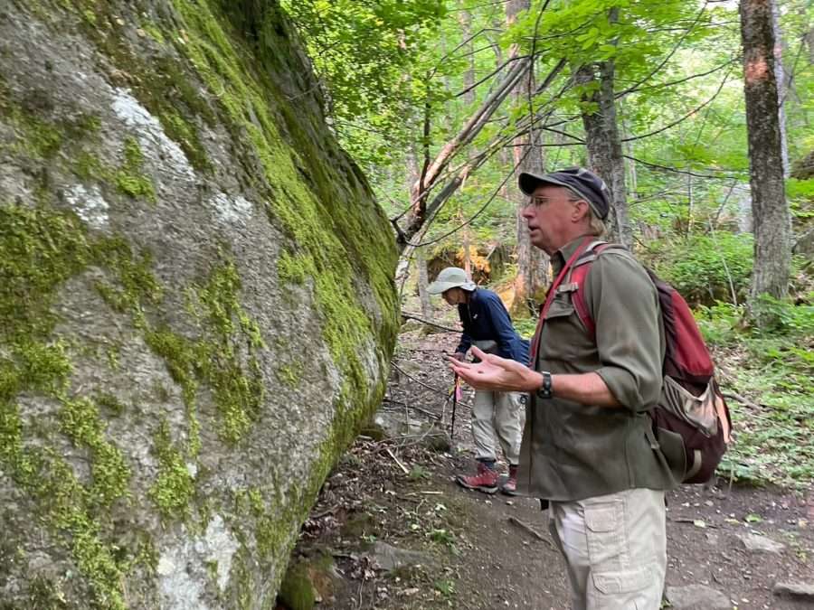 Tom Phillips inspects a boulder in the shadow of Poke-O-Moonshine.
