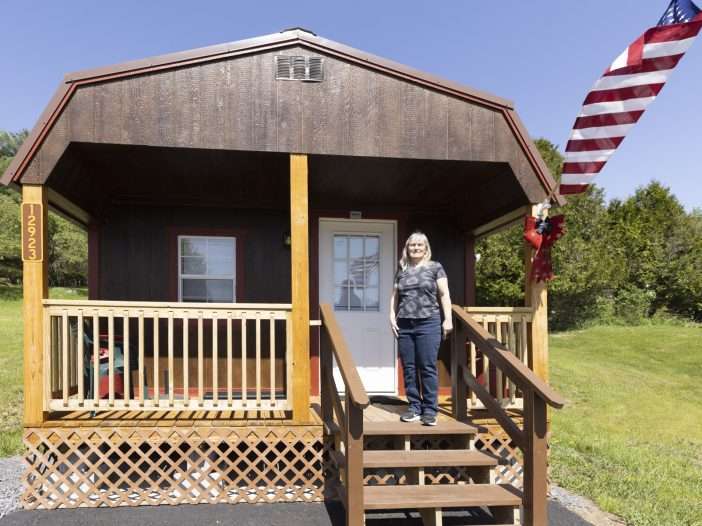 woman standing on porch of converted shed