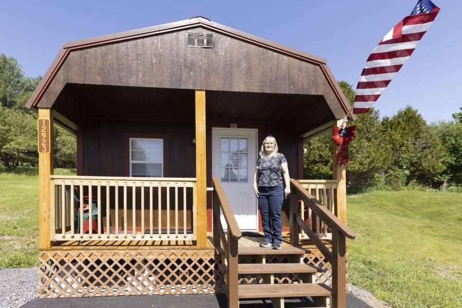 woman standing on porch of converted shed