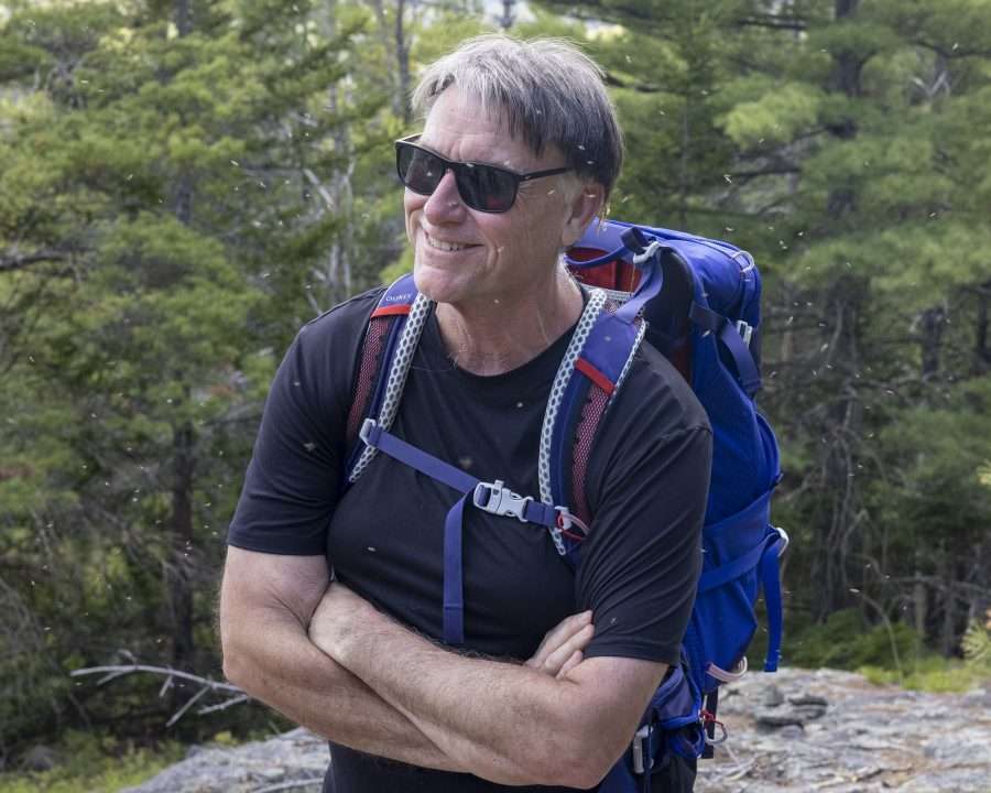 hiker with sunglasses and backpack