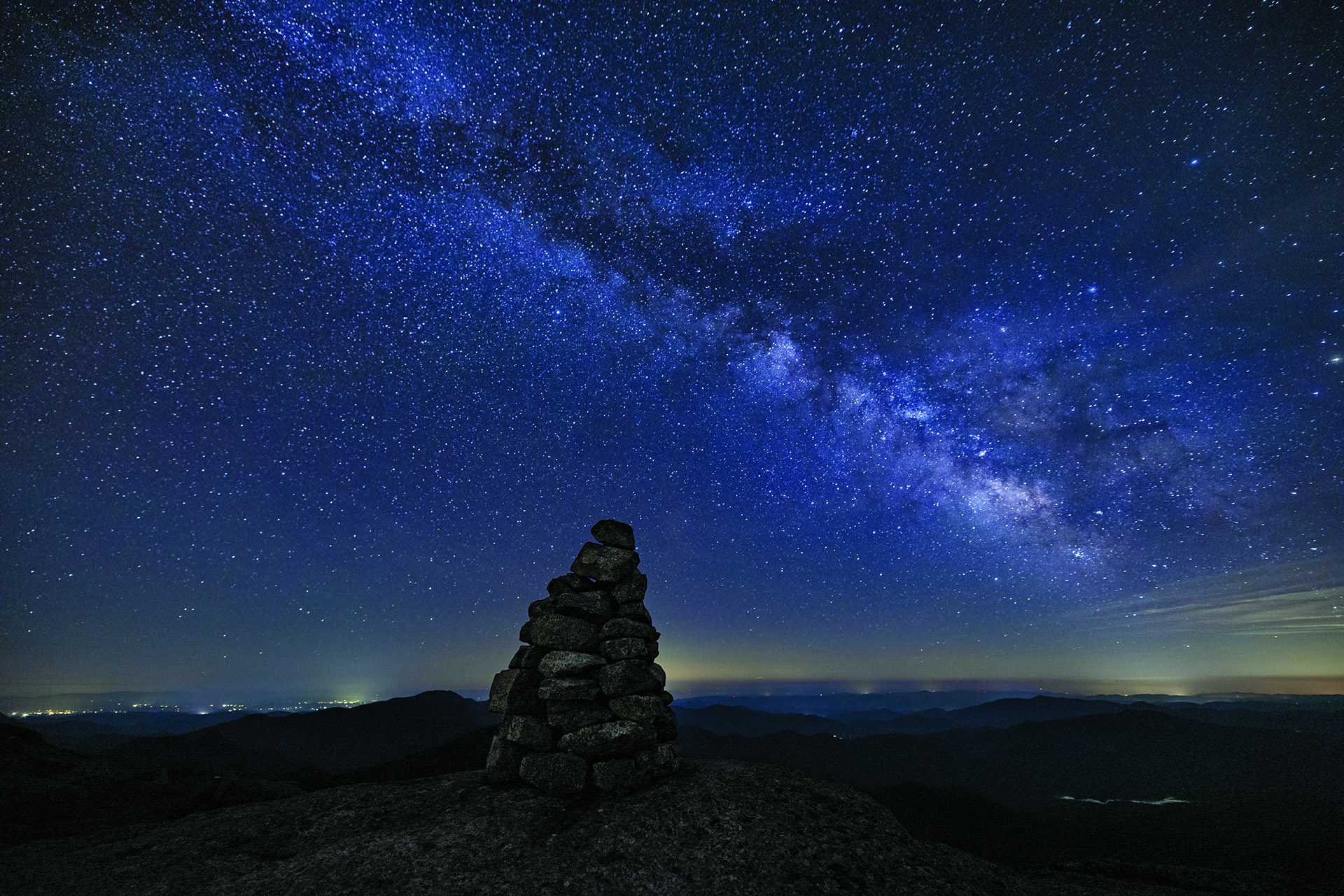 Mount Marcy under the
Milky Way with artificial
lights of Plattsburgh, center,
Lake Placid, left, and
Champlain Valley towns
illuminating the horizon.
Photo by Jonathan Esper