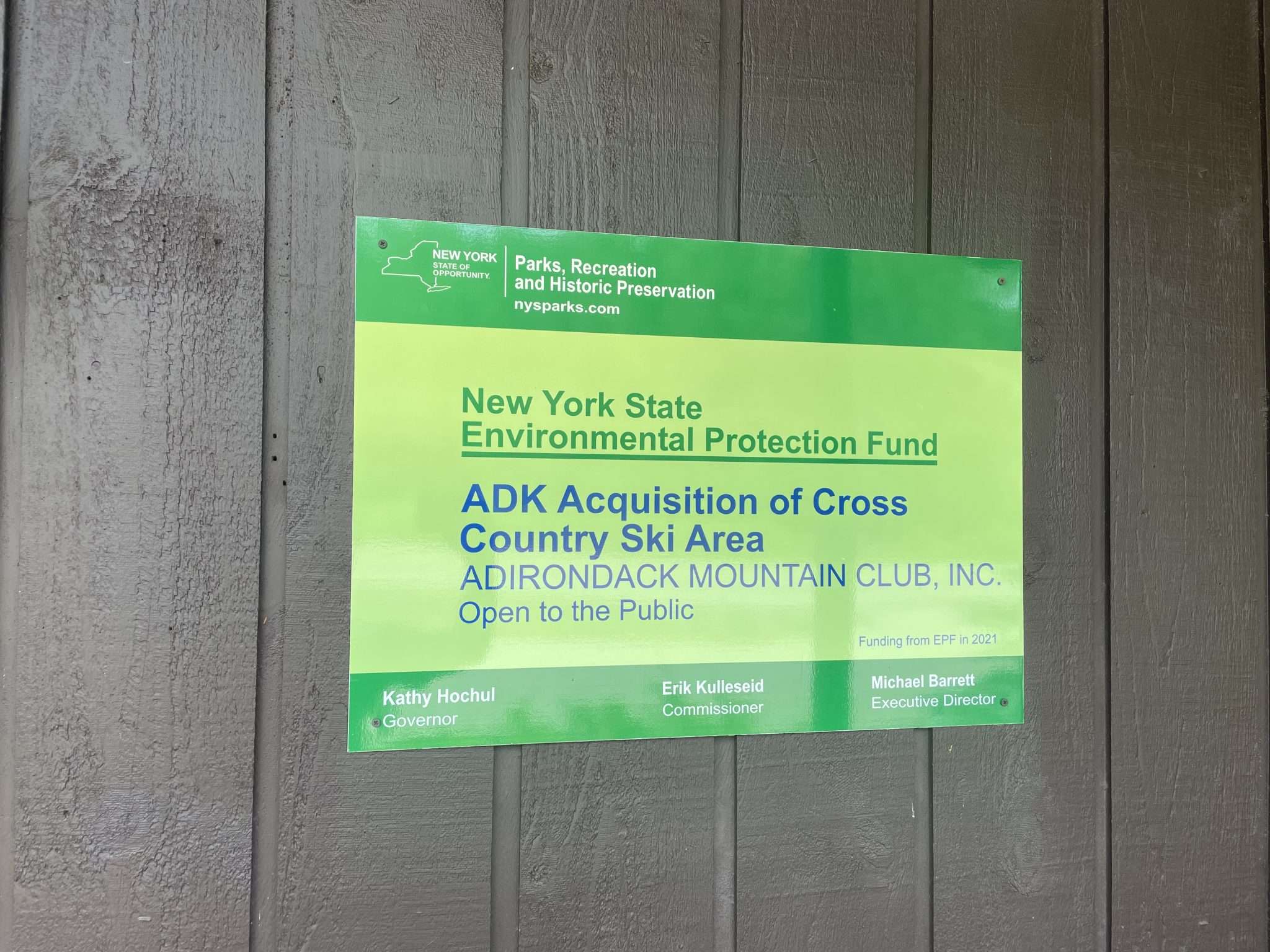 A sign posted on the Adirondack Mountain Club's Cascade Welcome Center indicates the state Environmental Protection Fund helped pay for the acquisition. Those funds, however, have not been disbursed and may not be, due to disagreement between ADK and the state over a conservation easement.