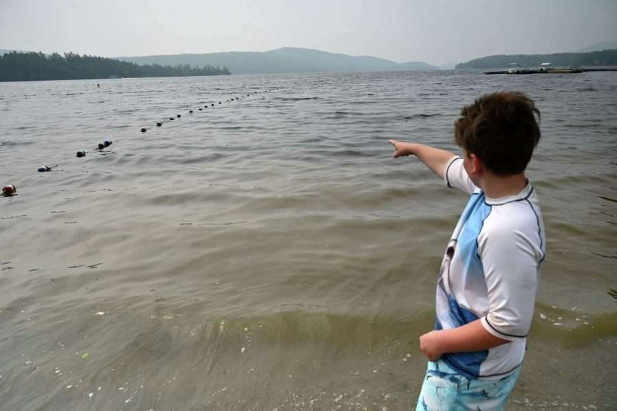 kid pointing to lake