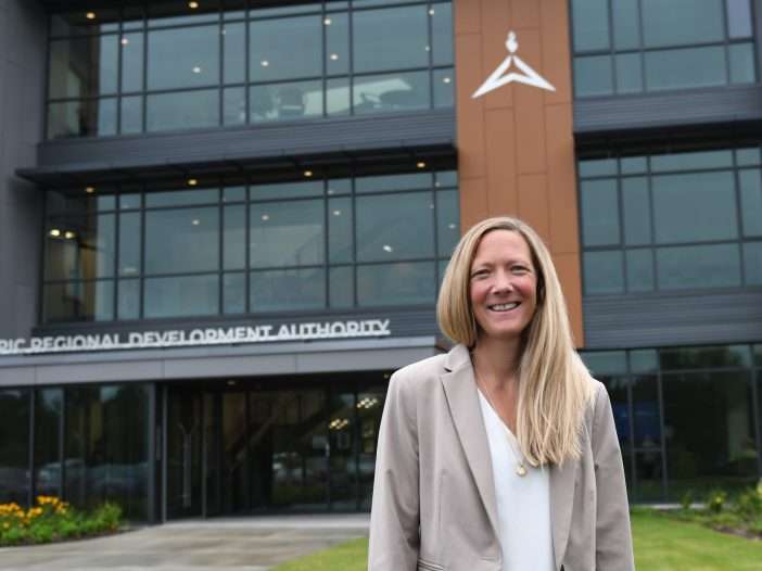 blond woman in front of ORDA building