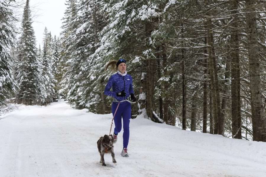 Sarah Keyes takes a winter run on a seasonal road in Lake Placid. Photo by Mike Lynch