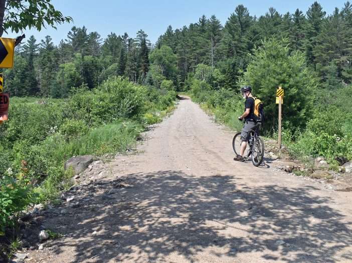 man biking on dirt road