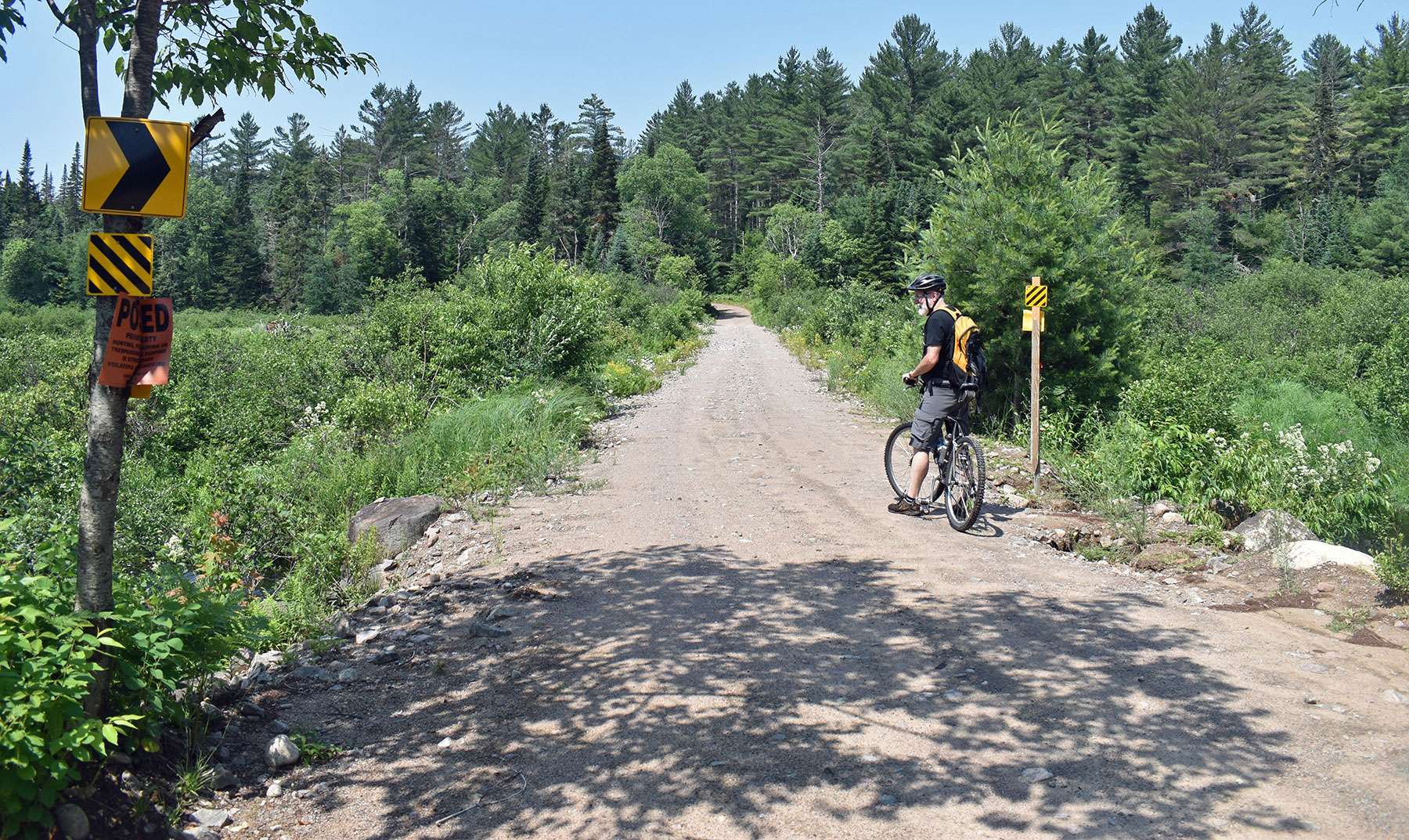 man biking on dirt road