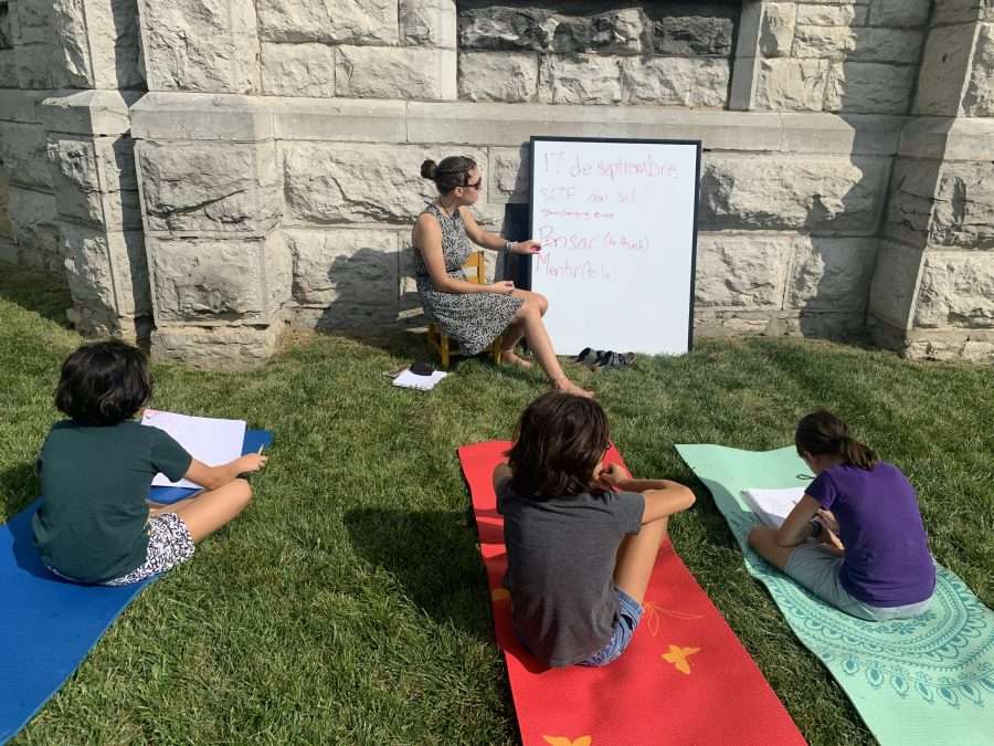 young woman teaching kids outside