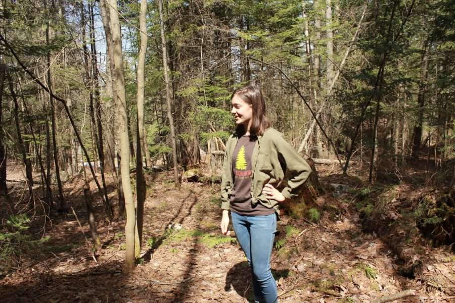 girl in green sweatshirt in the woods