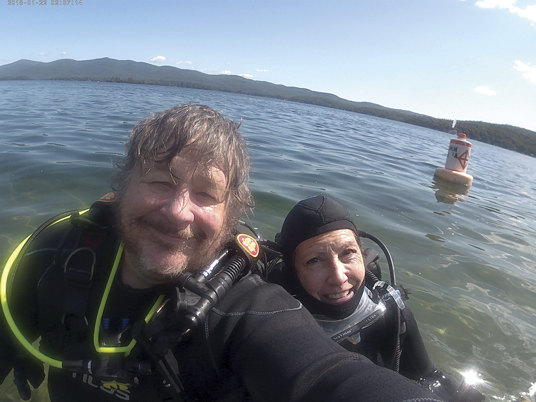 Michael Sean Gormley and Denis Snyder take a breath at the surface while scuba diving in Blue Mountain Lake. Photo by Michael Sean Gormley