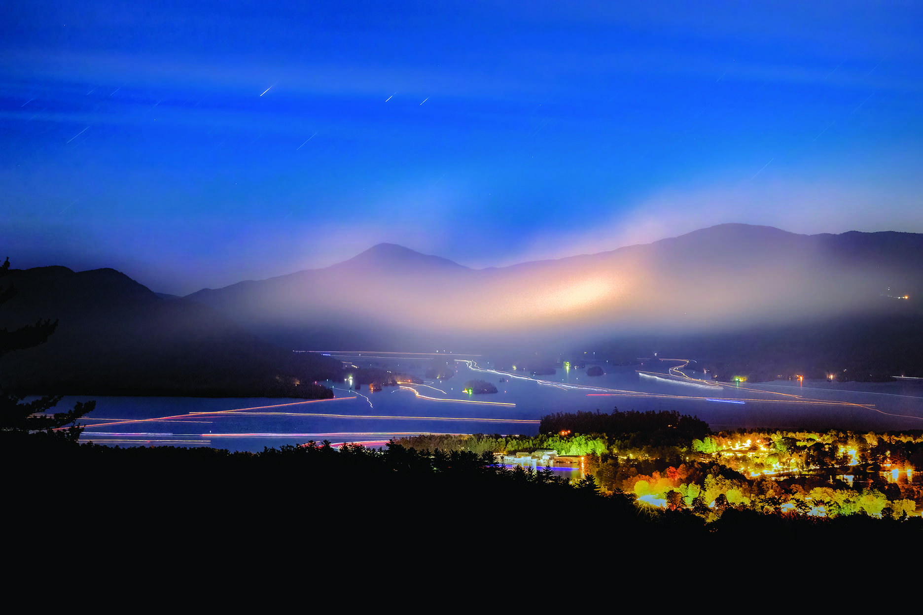 The lights of Bolton
Landing illuminate the
foreground as does
smoke in the sky and
boat traffic on Lake
George after Fourth of
July fireworks. Photo by William Adamczak
WILLIAM ADAMCZAK