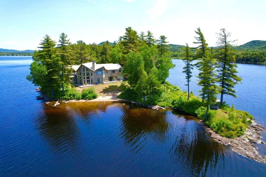 "Camp on a Point," the former summer residence of Marylou Whitney and John Hendrickson on Little Tupper Lake, is for sale.