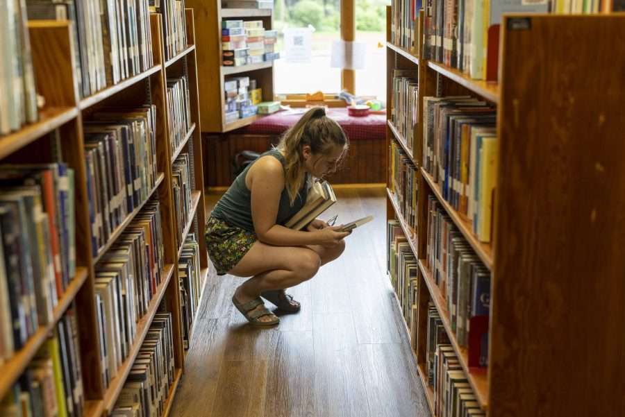 Kate Berdan looks over a book at the Keene Library in July. Photo by Mike Lynch