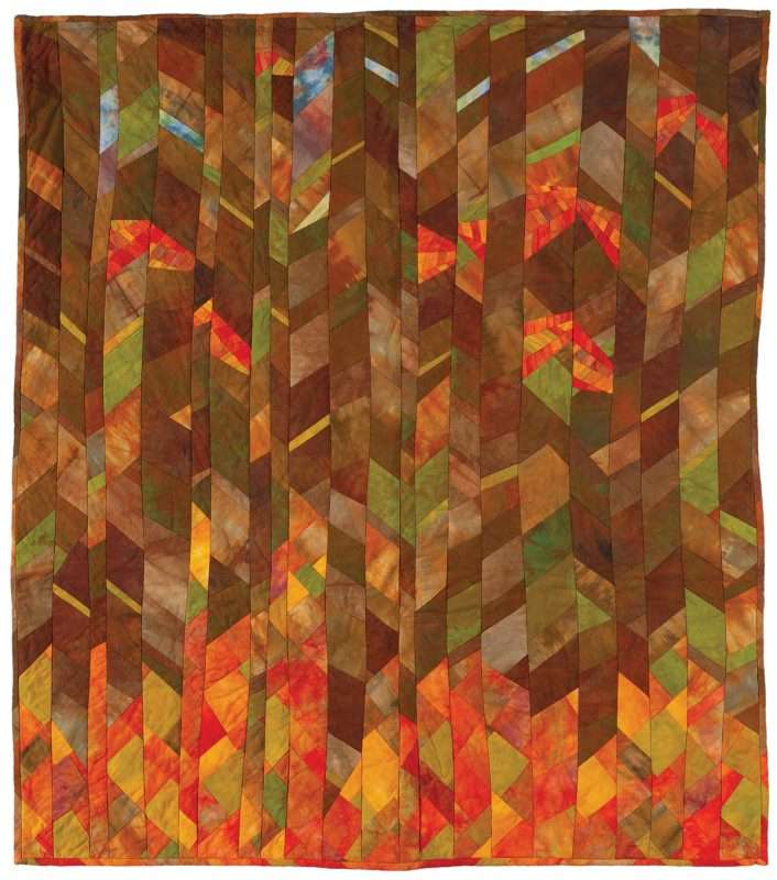 quilt in colors of orange, red and brown