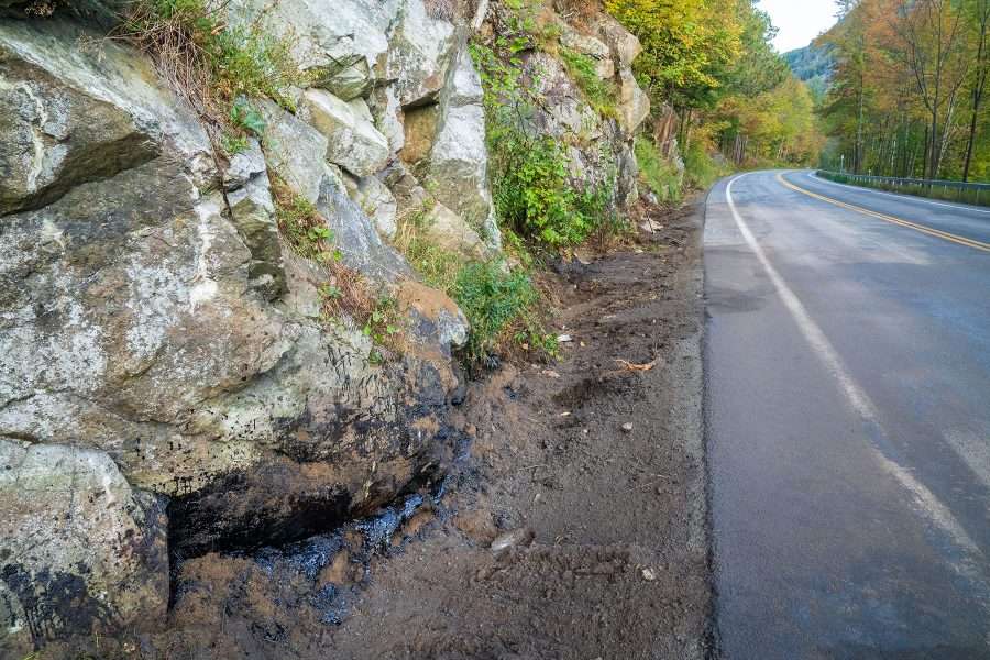 Truck coat, similar to driveway sealant, was contained with sand and booms at the site of the crash.