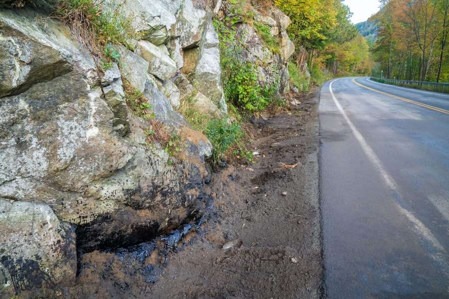 Truck coat, similar to driveway sealant, was contained with sand and booms at the site of the crash. 

