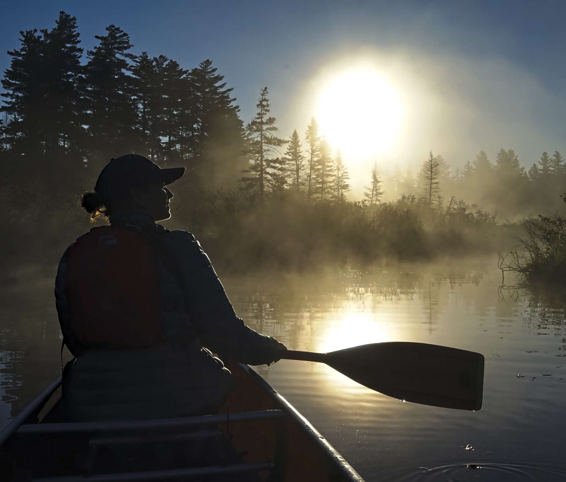 Paul Smith's researcher Michale Glennon surveys boreal birds in a  peatland in the top of the Black River Watershed at Shingle Shanty Preserve and Research Station. Photo by Steve Langdon