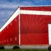 One of the distillery buildings at Whistle Pig in Mineville, with a new building behind it. It appears that the bottom of the building has been cleaned.