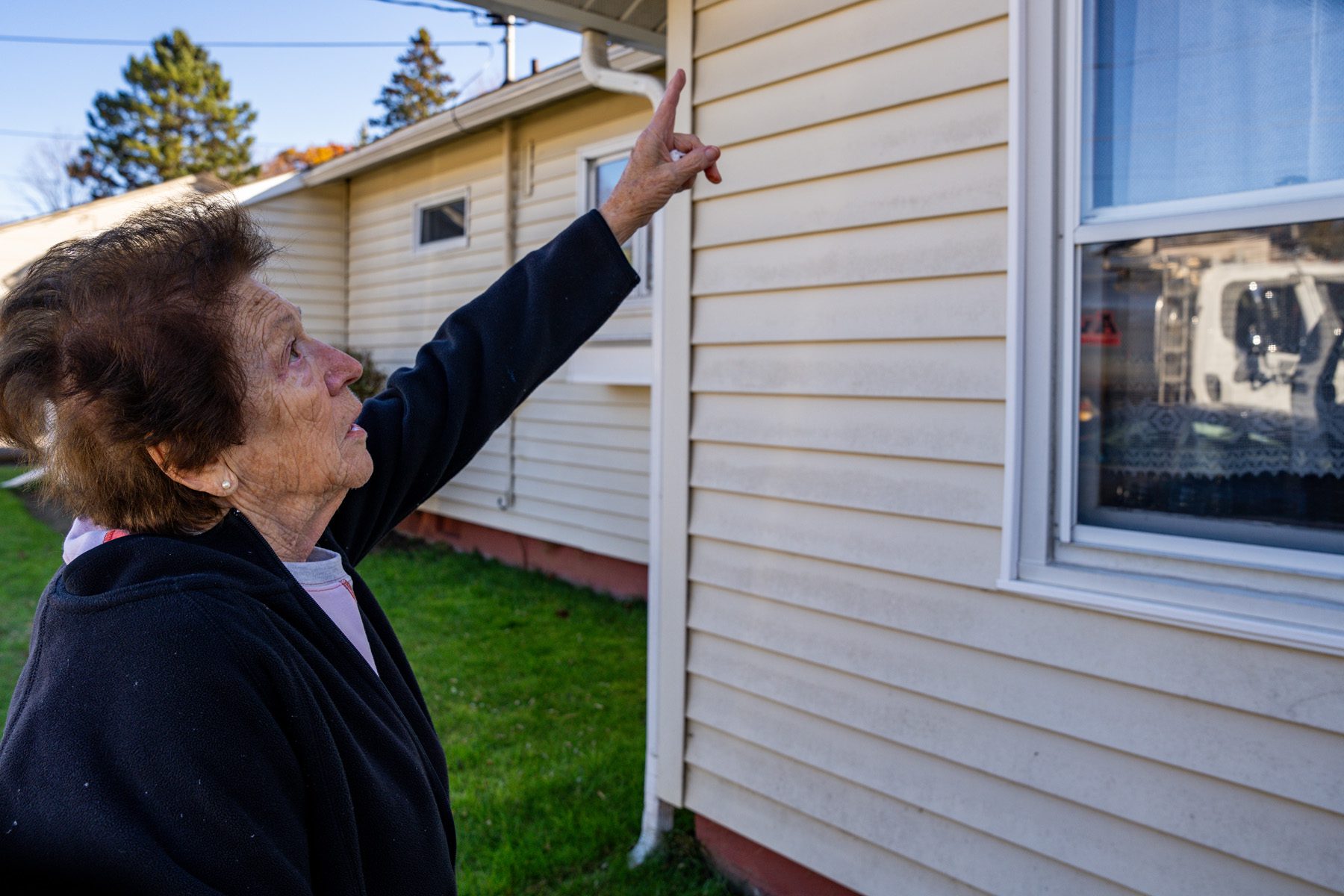 Sandra Ploufe, 83, shows where black fungus has come back after having her house cleaned recently.