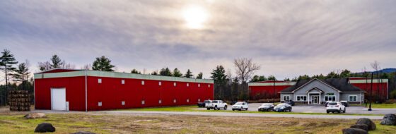 The grey building on the right, is owned by the Essex County Industrial Development Agency and occupied by High Peaks Hospice and Palliative Care for administration, tested positive for whiskey fungus. It has distillery buildings on three sides.