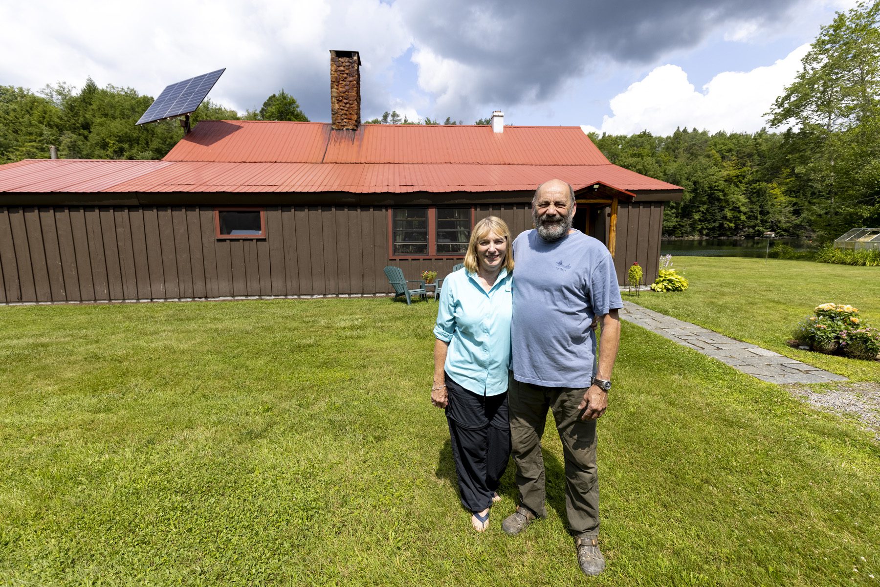 Rodney Morgan and Donna Kagiliery in front of their home in the southern Adirondacks