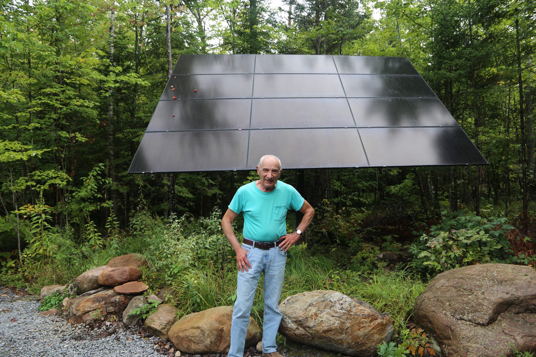 Jim Visconti stands in front of his home's solar panels.