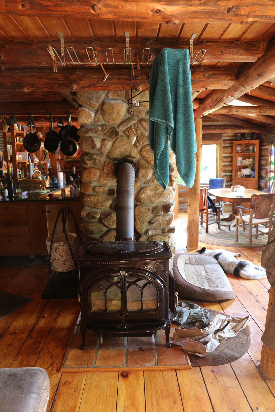 A wood stove with a clothes-drying rack hanging above.