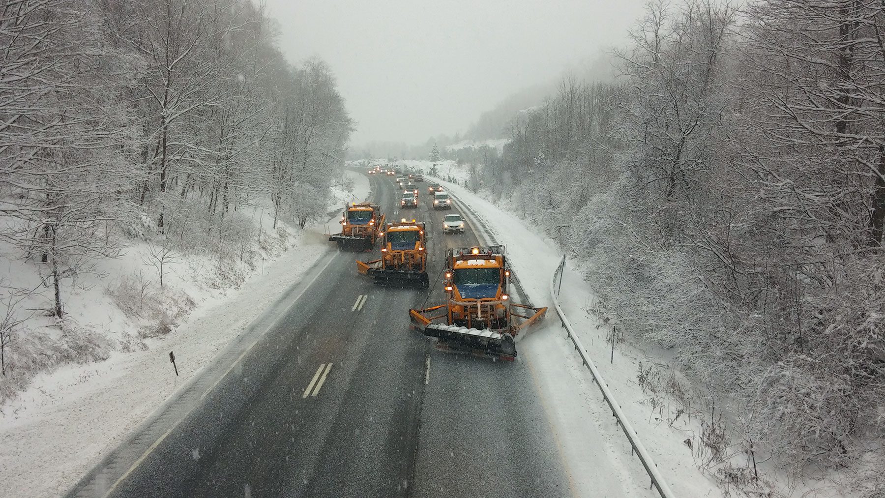 snowplows dropping rod salt on snowy road